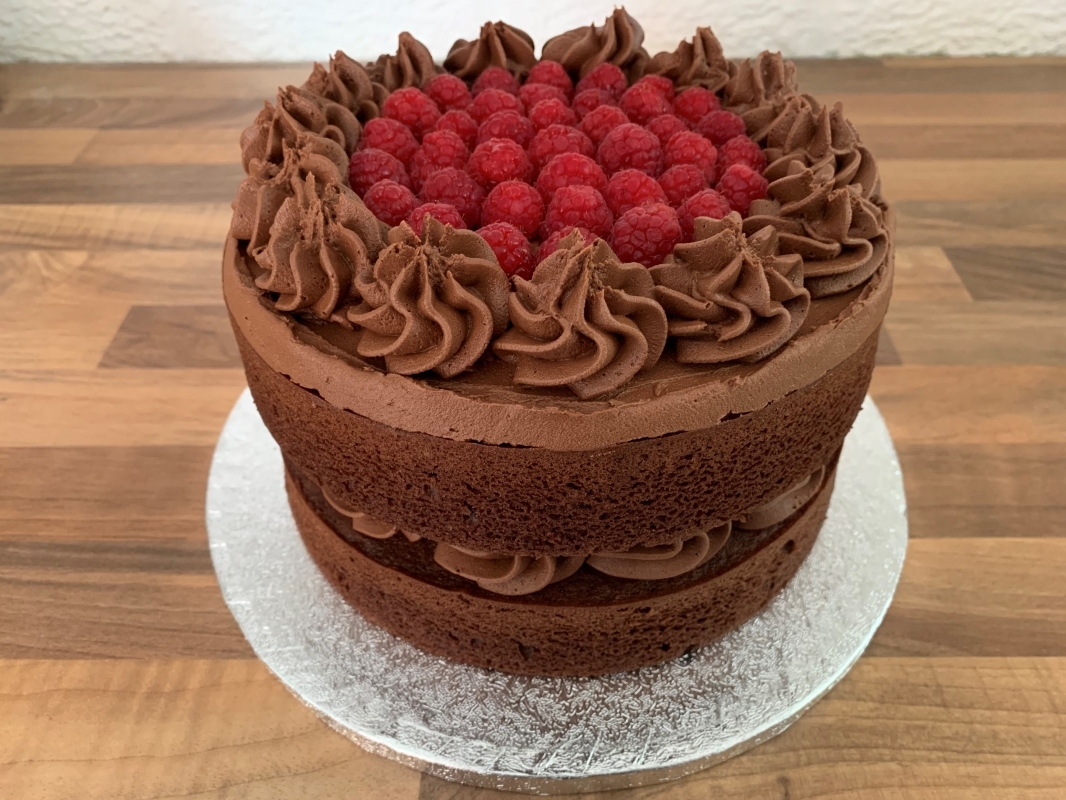 gluten-free-chocolate-celebration-cake-with-fresh-raspberries-decoration-june-2023.jpg